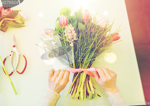 Image of close up of woman making bunch at flower shop