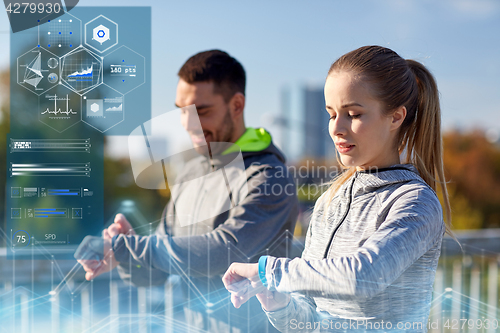 Image of couple with heart-rate trackers training outdoors