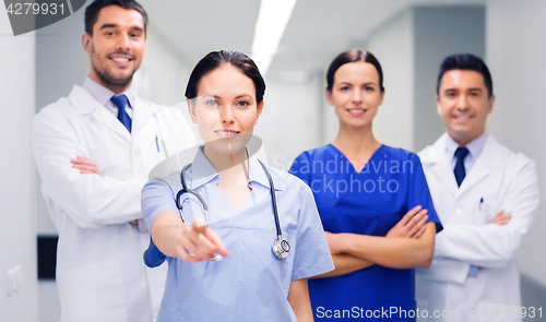 Image of group of medics pointing finger on you at hospital