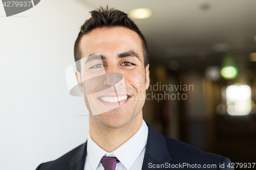 Image of businessman in suit at hotel corridor 