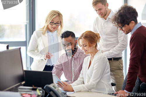 Image of business team with tablet pc computer in office