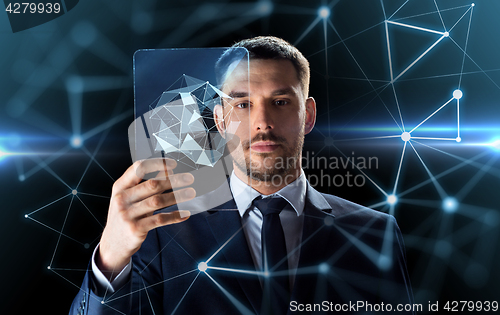 Image of businessman working with transparent tablet pc