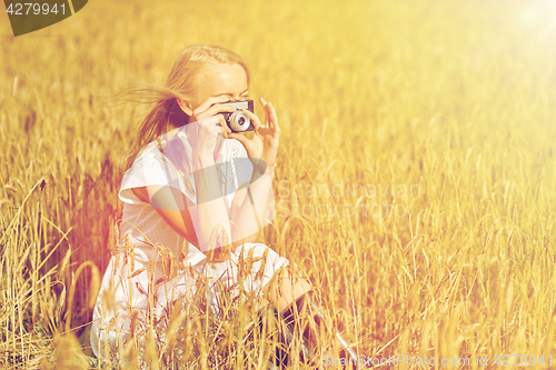 Image of woman taking picture with camera in cereal field