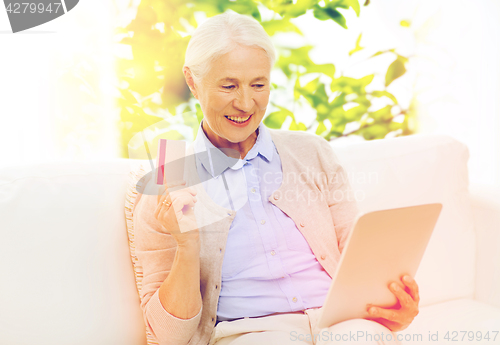 Image of senior woman with tablet pc and credit card