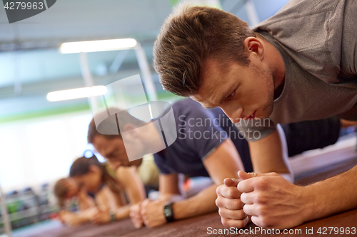 Image of group of people exercising in gym