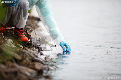 Image of Laboratory assistant takes water samples