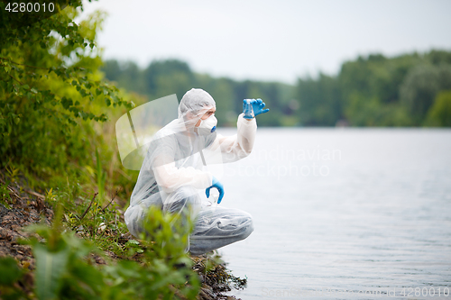 Image of Ecologist with bulb on river