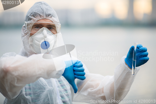 Image of Biologist in respirator with test-tube