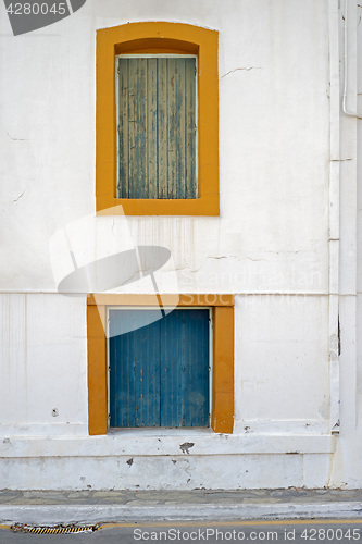 Image of abandoned wooden house with boarded up windows