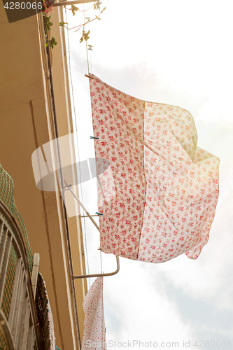 Image of Bed sheets drying in the street