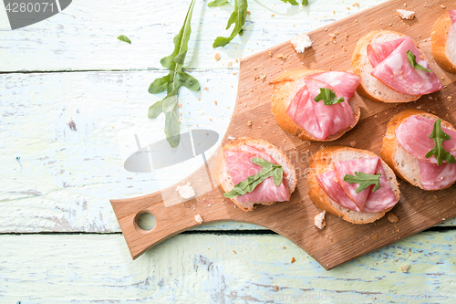 Image of Baguette , ham on wooden table