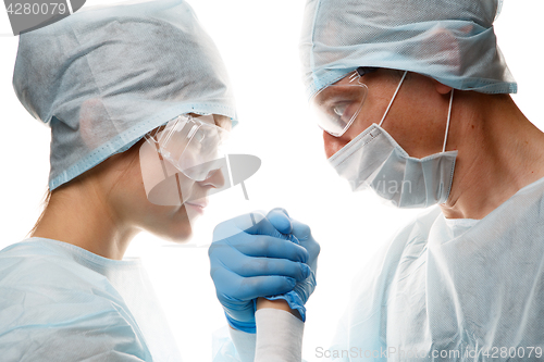 Image of Doctors in uniform make handshake