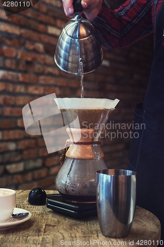 Image of Barista brewing coffee