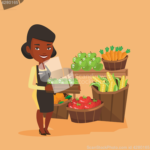 Image of Supermarket worker with box full of apples.