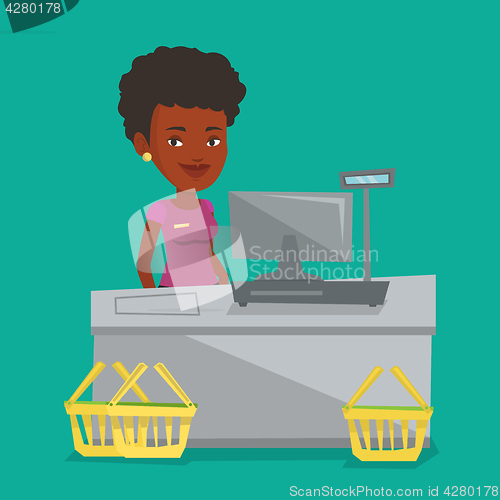 Image of Cashier standing at the checkout in supermarket.