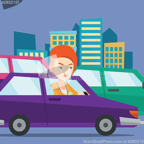 Image of Angry caucasian woman in car stuck in traffic jam.