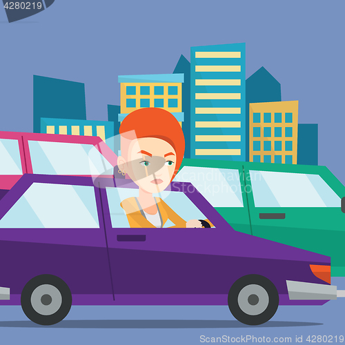 Image of Angry caucasian woman in car stuck in traffic jam.