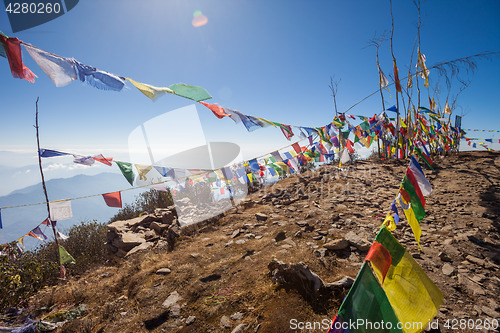 Image of Buddhist prayer flags on a mountaintop in the Himalayas