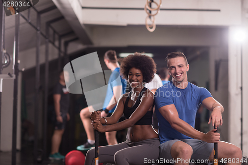 Image of multiethnic couple after workout with hammer