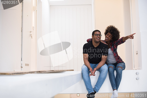 Image of couple having break during moving to new house