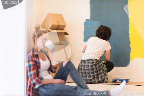 Image of young couple doing home renovations