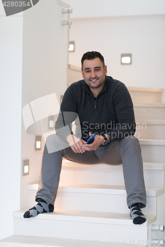 Image of man sitting on the stairs
