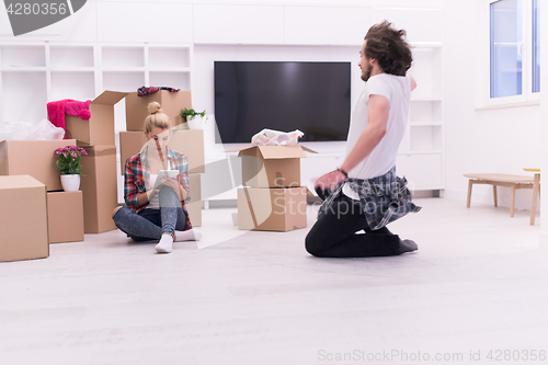 Image of young couple moving  in new house