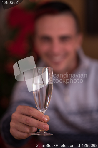 Image of Happy young man with a glass of champagne