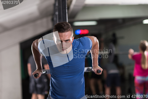 Image of man doing exercises parallel bars