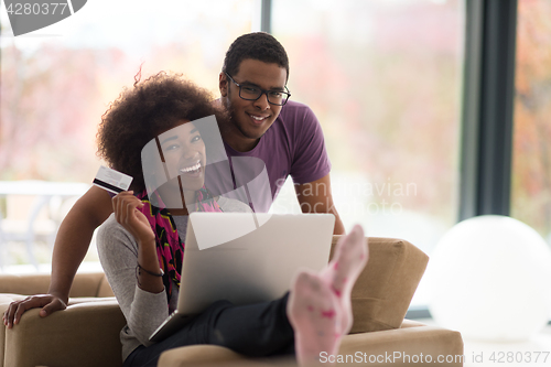 Image of african american couple shopping online