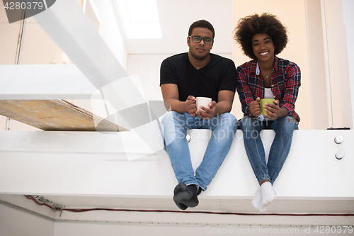 Image of couple having break during moving to new house