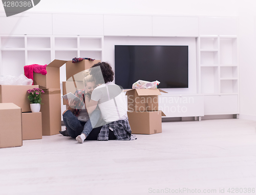 Image of young couple moving  in new house