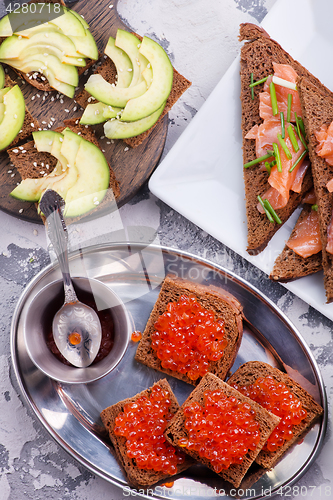 Image of bread with red salmon caviar 