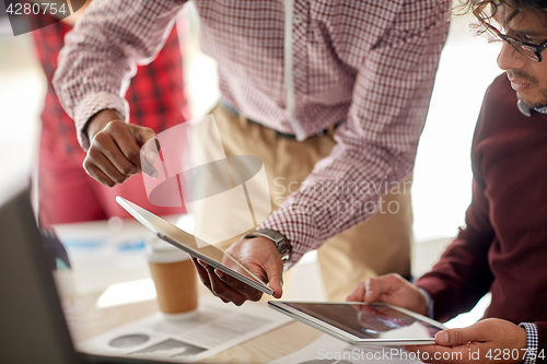 Image of businessmen with tablet pc and charts at office