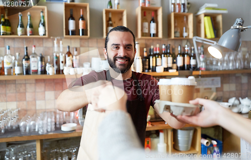 Image of man or waiter serving customer at coffee shop