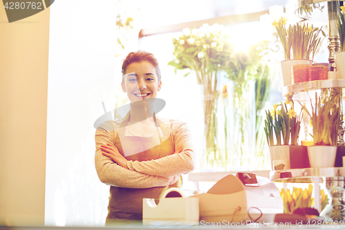 Image of smiling florist woman at flower shop cashbox