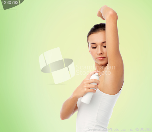 Image of woman with antiperspirant deodorant over white