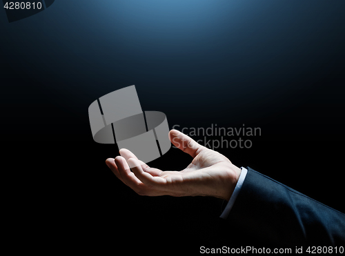 Image of close up of businessman hand over black