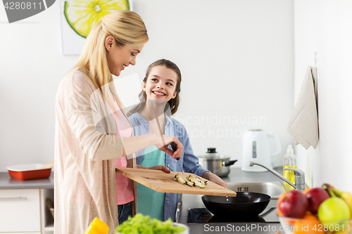Image of happy family cooking food at home kitchen