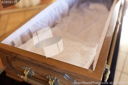 Image of close up of open empty coffin in church