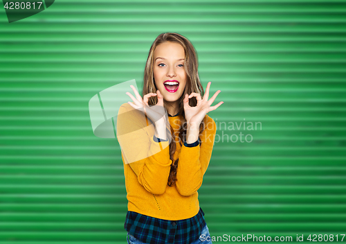 Image of happy young woman or teen showing ok hand sign