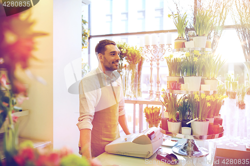 Image of florist man or seller at flower shop counter