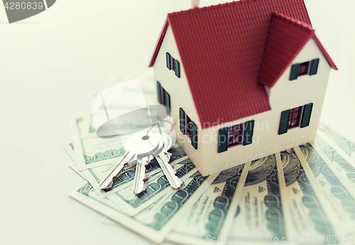 Image of close up of home model, money and house keys