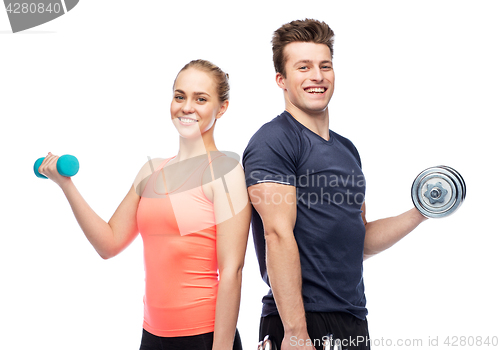 Image of sportive man and woman with dumbbells