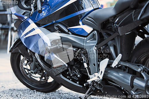 Image of Motorcycle luxury items close-up: headlights, shock absorber, wheel, wing, toning.