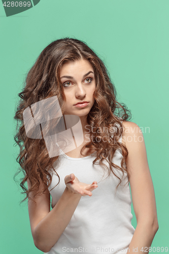 Image of Frustrated young woman posing on blue