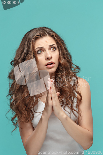 Image of The Woman is looking imploring over gray background