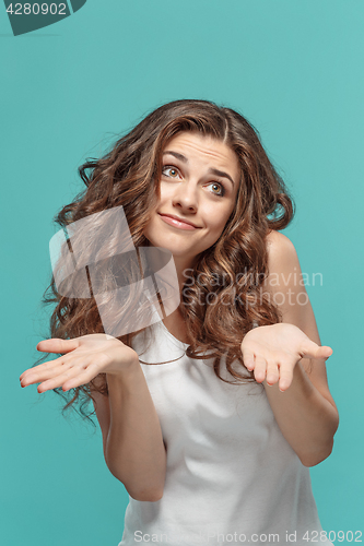 Image of Frustrated young woman posing on blue
