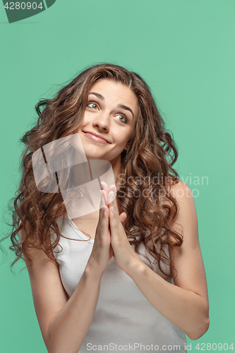 Image of The Woman is looking imploring over gray background