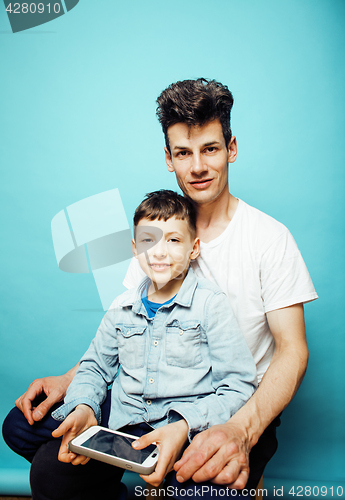 Image of young pretty man model with little cute son playing together, lifestyle modern people concept, family male 